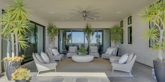 Outdoor patio with seating area and large windows