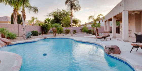 Pool with palm trees and outdoor seating area