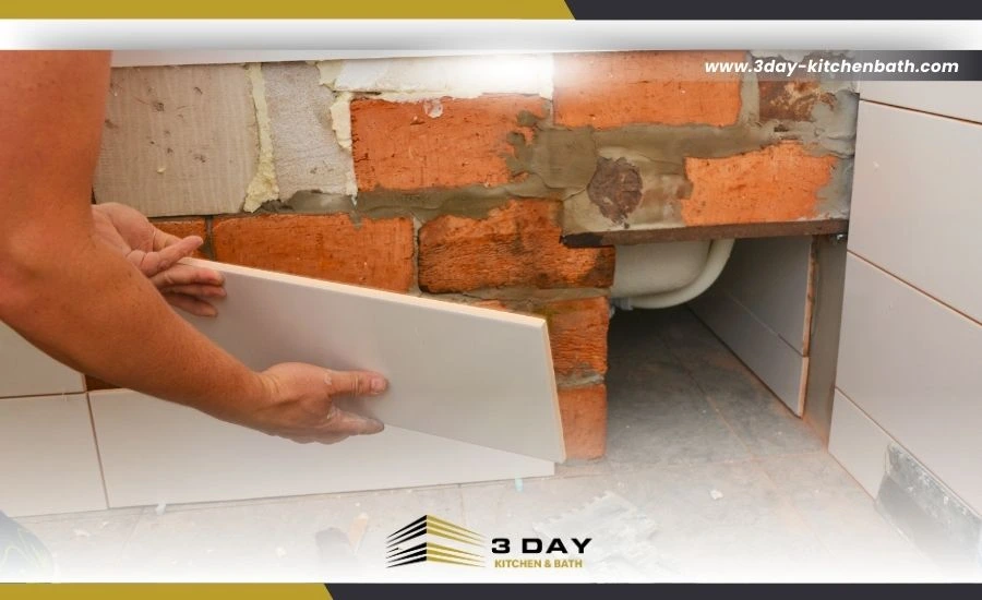 Bathroom remodel in progress with plumbing and tiles