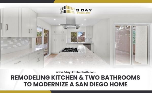 A bright spacious kitchen with a long marble patterned island white shaker cabinets a stainless steel range hood and sliding glass doors letting in natural light