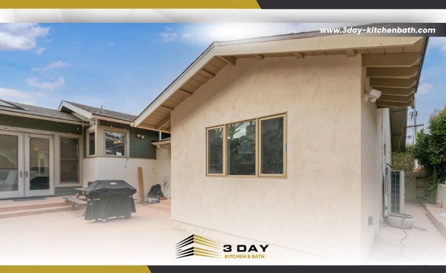 Exterior view of a home addition featuring light stucco and new windows by 3 Day Kitchen & Bath.