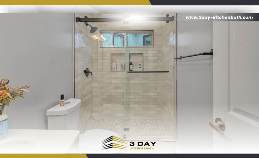 Modern bathroom featuring a glass shower with light tile and black hardware by 3 Day Kitchen & Bath.